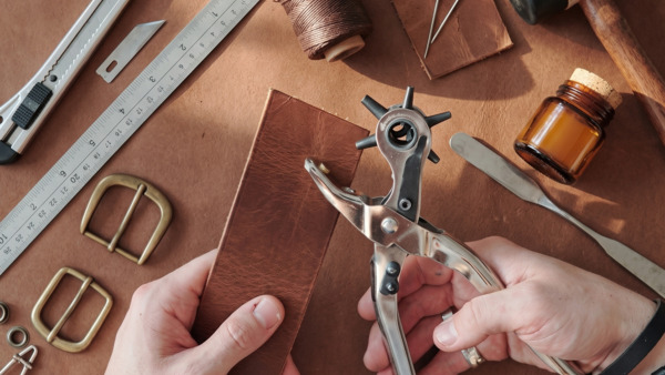 Los 8 materiales para hacer carteras de cuero artesanal sobre superficie de trabajo
